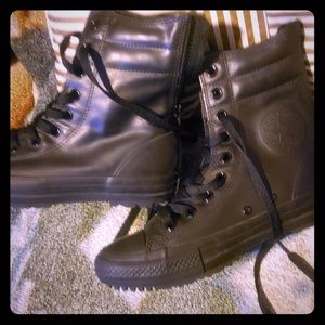 Converse black leather high tops.